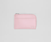 Pink wallet with a zipper on a light gray background