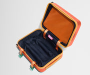 The Kids Carry-On suitcase in Poppy Orange shown open and empty on its side to show capacity