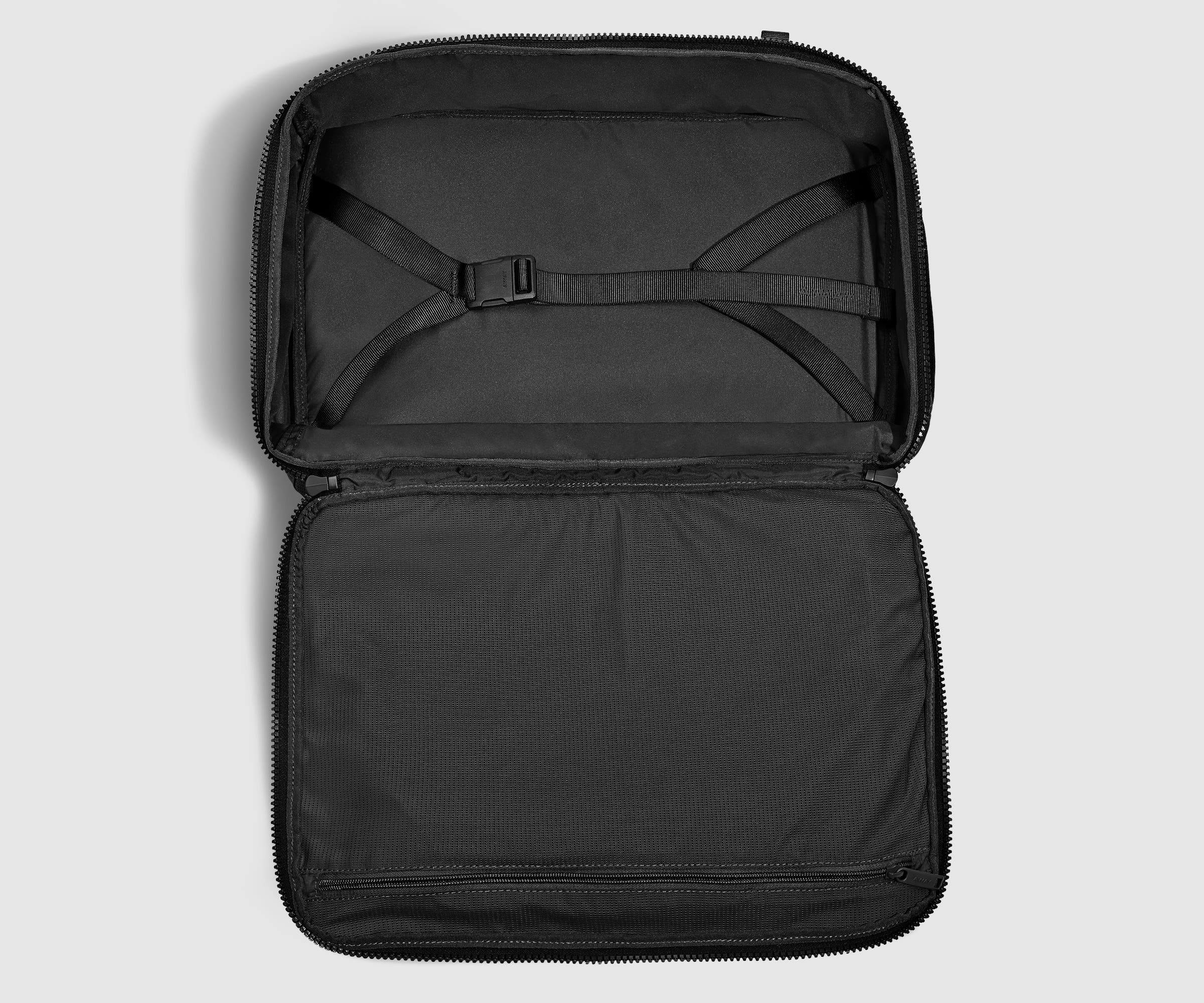 Open, unpacked backpack showing the compression straps