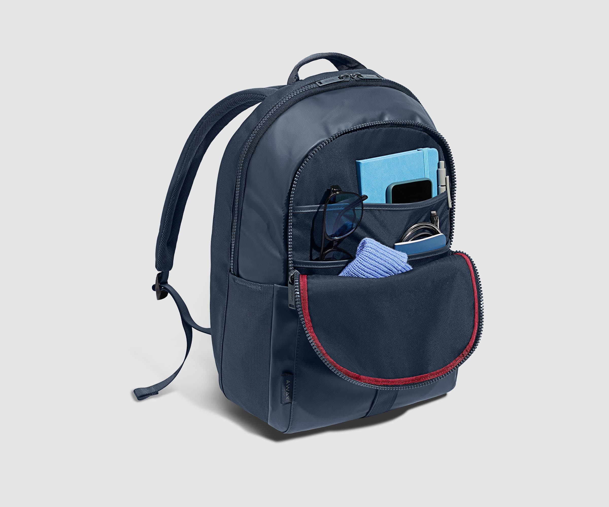 Front pocket packed with a noteboook, phone, beanie, and other daily essentials