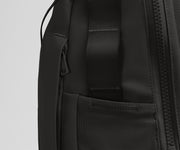 Close up view of the hidden zipper pocket, water bottle pocket, and side webbing loops