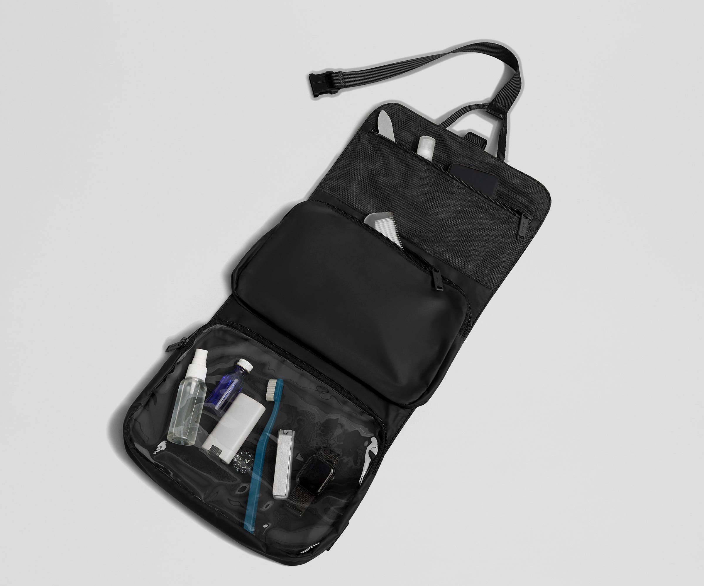 Hanging Toiletry Bag packed with nail care, a comb, and other toiletries like a toothbrush