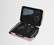 The Bigger Carry-On suitcase in Blush Pink shown open on its side and packed with Away's packing organizers to show capacity and the interior compression system, designed to help you pack more in