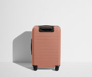 Back product view of The Bigger Carry-On suitcase in Clay Pink