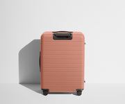 Back product view of The Medium Flex suitcase in Clay Pink