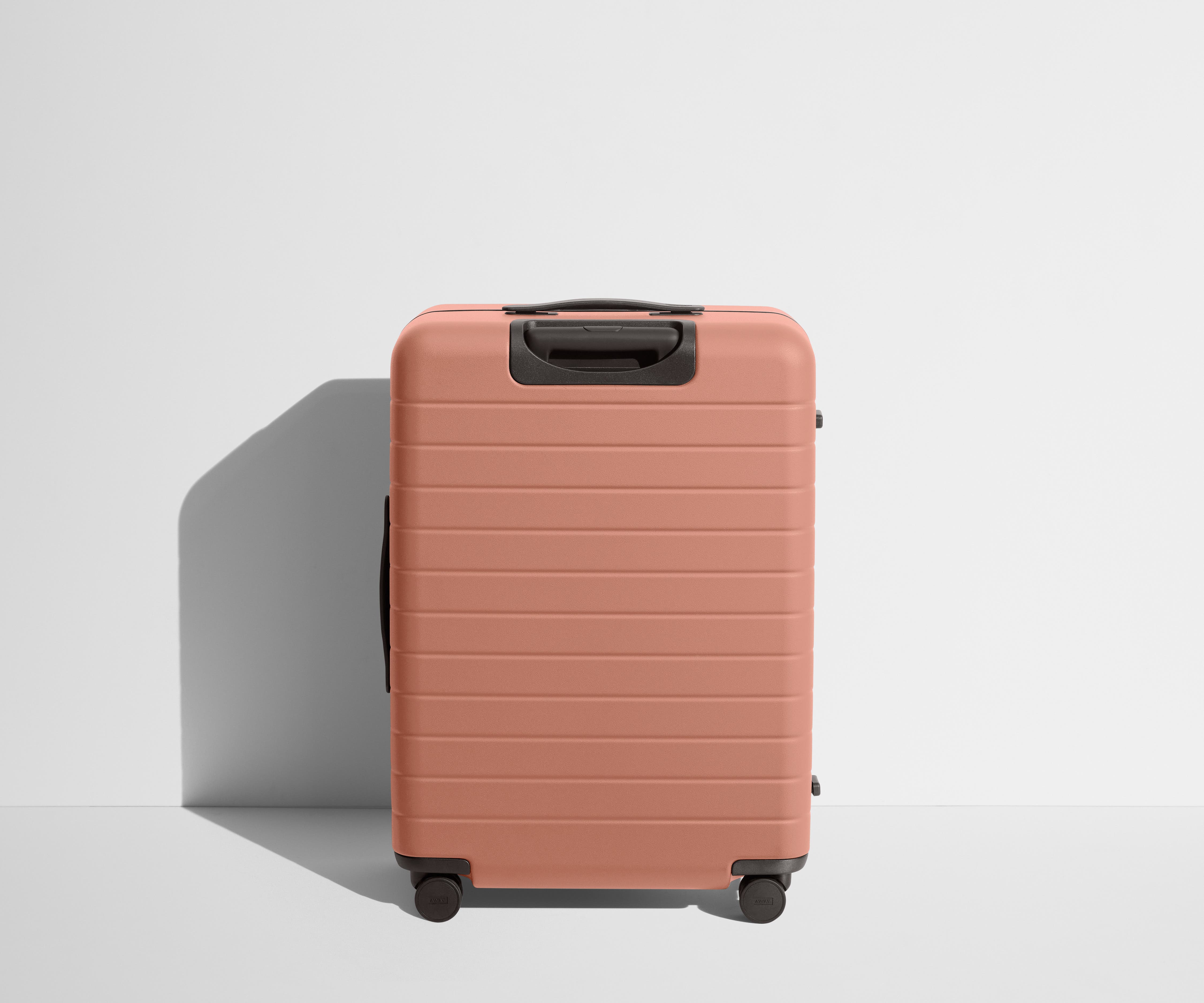 Back product view of The Medium Flex suitcase in Clay Pink