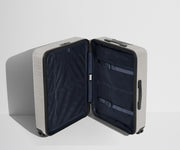 The Medium suitcase in Cloud Gray shown open in an upright position to show interior organization and compression system