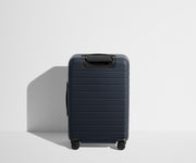 Back product view of The Bigger Carry-On Flex suitcase in Navy Blue