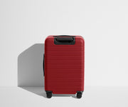 Back product view of The Bigger Carry-On Flex suitcase in Tango Red