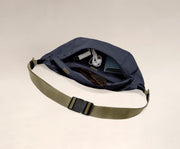 Main compartment packed with a wallet, headphones, and sunglasses