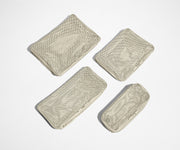 Set of four unpacked Packing Cubes laying flat