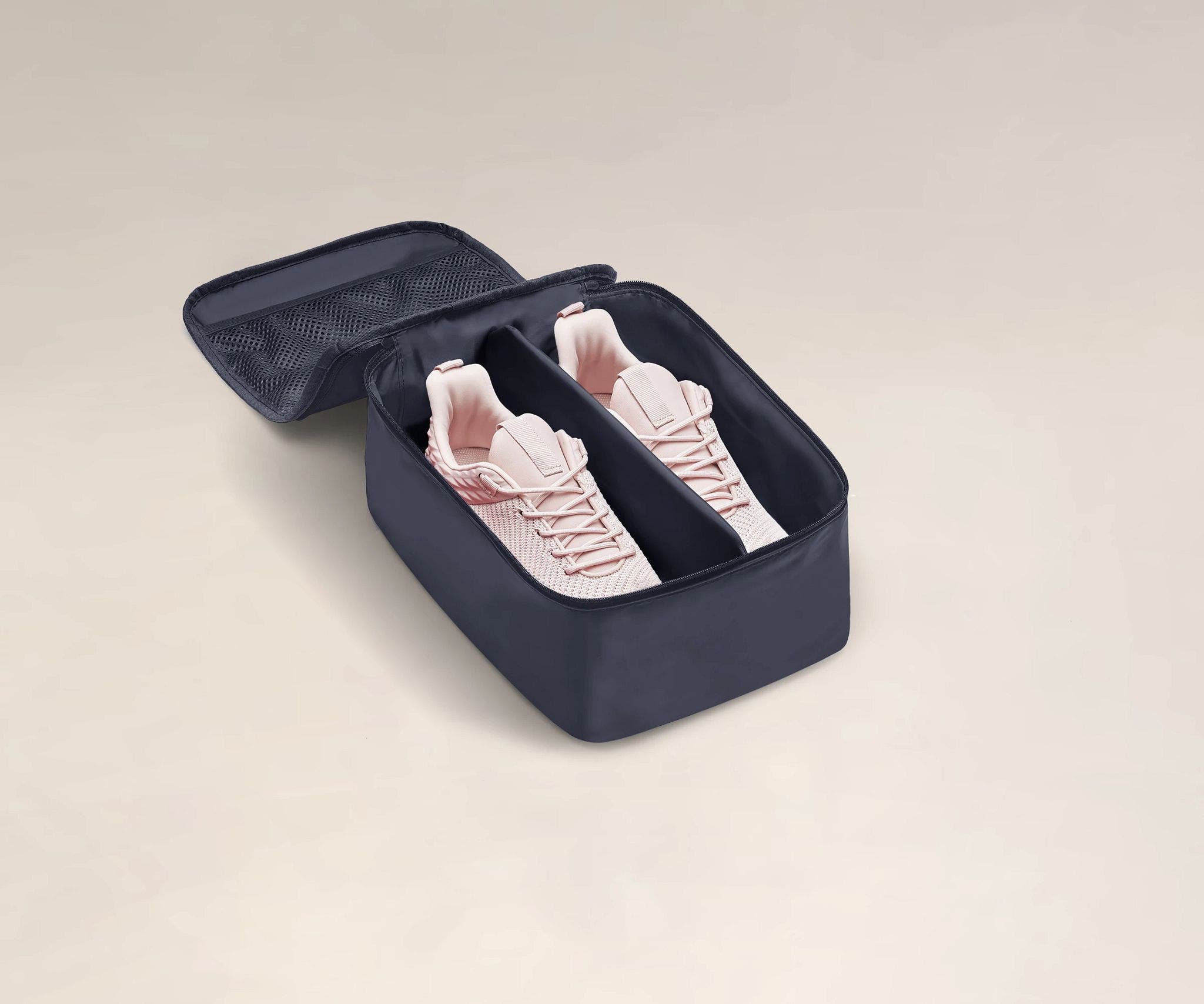 A pair of sneakers in a small Shoe Cube
