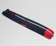 Navy and red ski bag on a light gray background