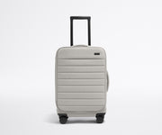 Front product view of The Softside Carry-On suitcase in Cloud Gray with raised handle