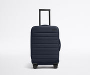 Front product view of The Softside Carry-On suitcase in Navy Blue with raised handle