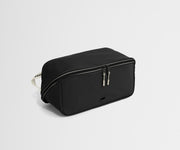 Black shoe bag with a strap on a light gray background