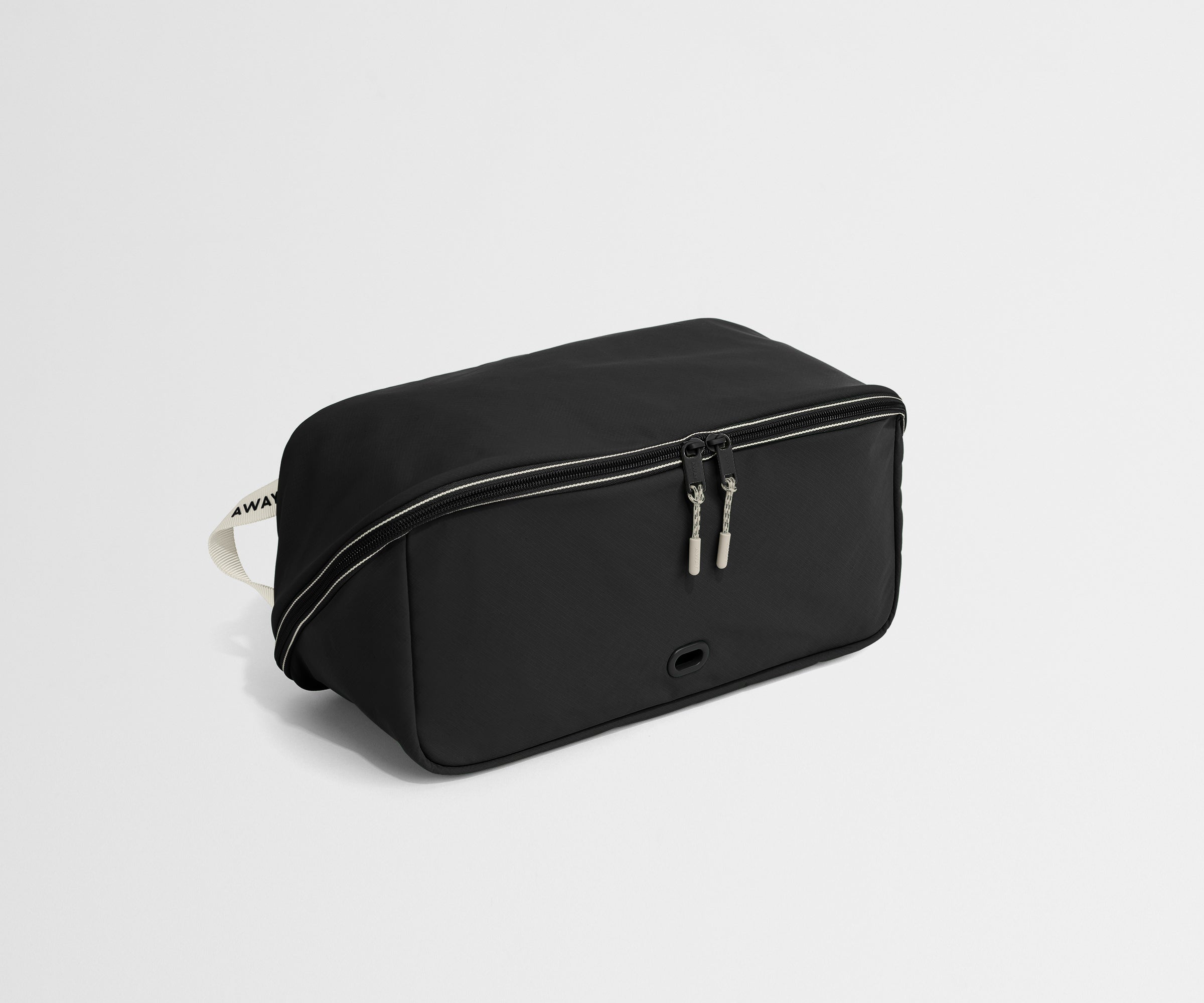 Black shoe bag with a strap on a light gray background