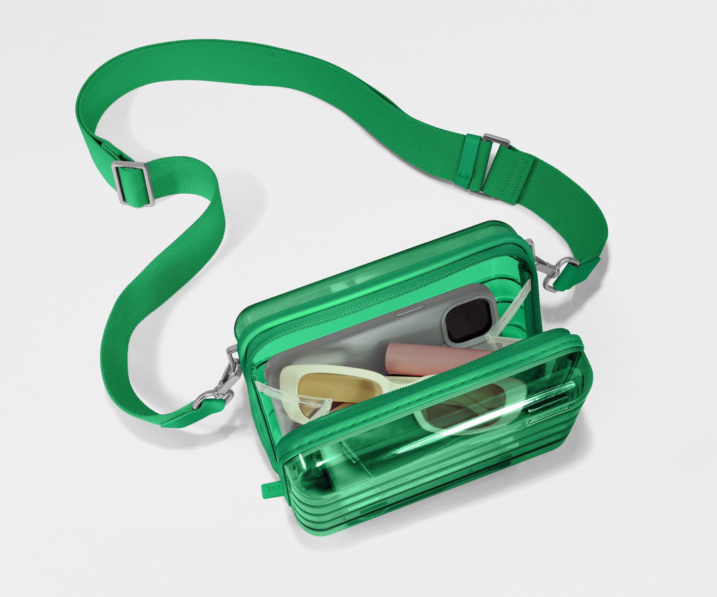 The Mini Crossbody packed with a phone, passport, and sunglasses