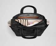 Back main compartment packed with adult travel essentials, including a laptop, notebook, and extra clothes
