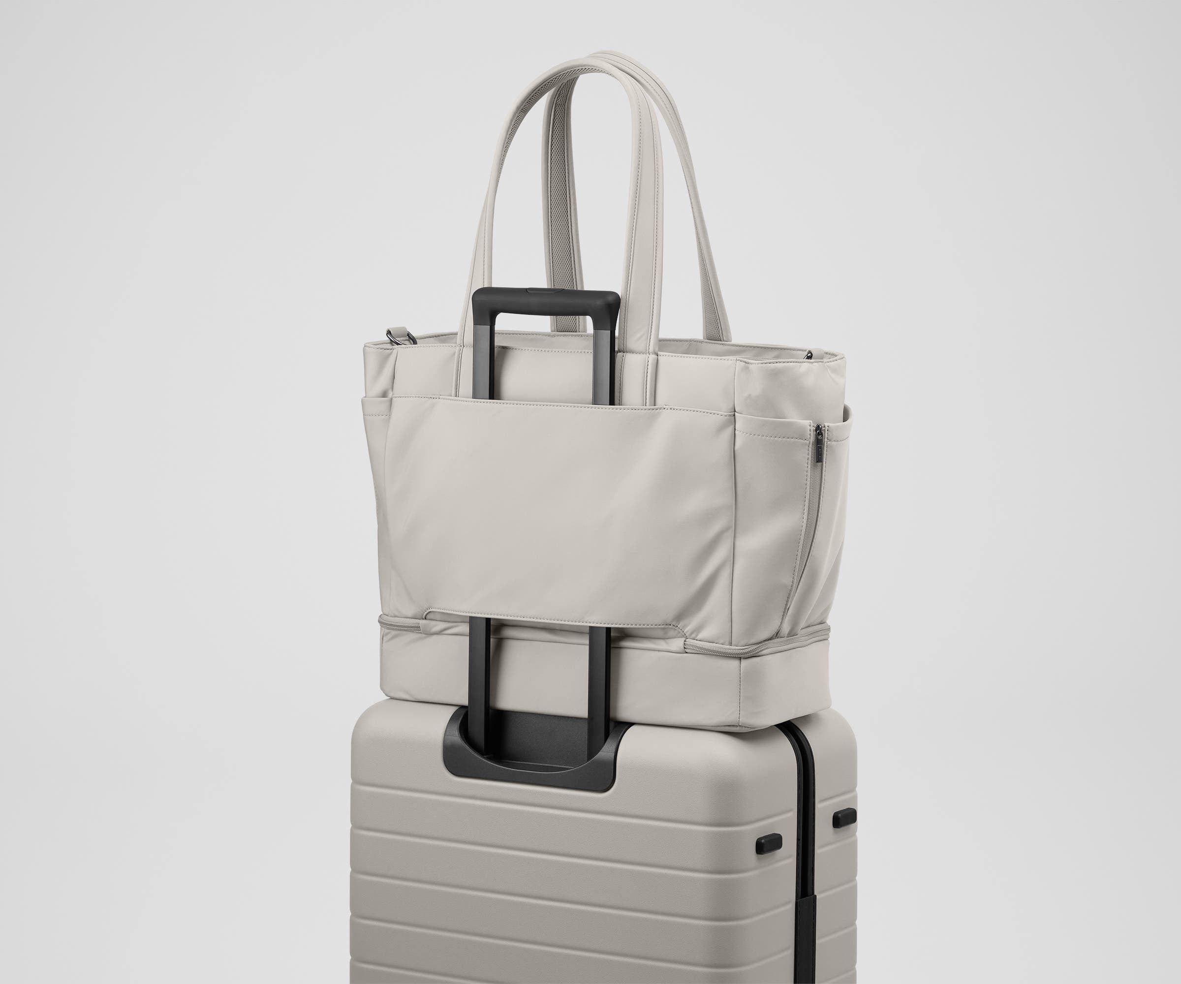 Double Diaper Tote on top of an Away suitcase by the trolley sleeve