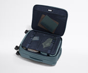 Open Softside Bigger Carry-On suitcase, with travel essentials in the front flap pocket and compression pad pockets