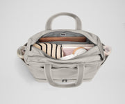 Back main compartment packed with adult travel essentials, including a laptop, notebook, and extra clothes