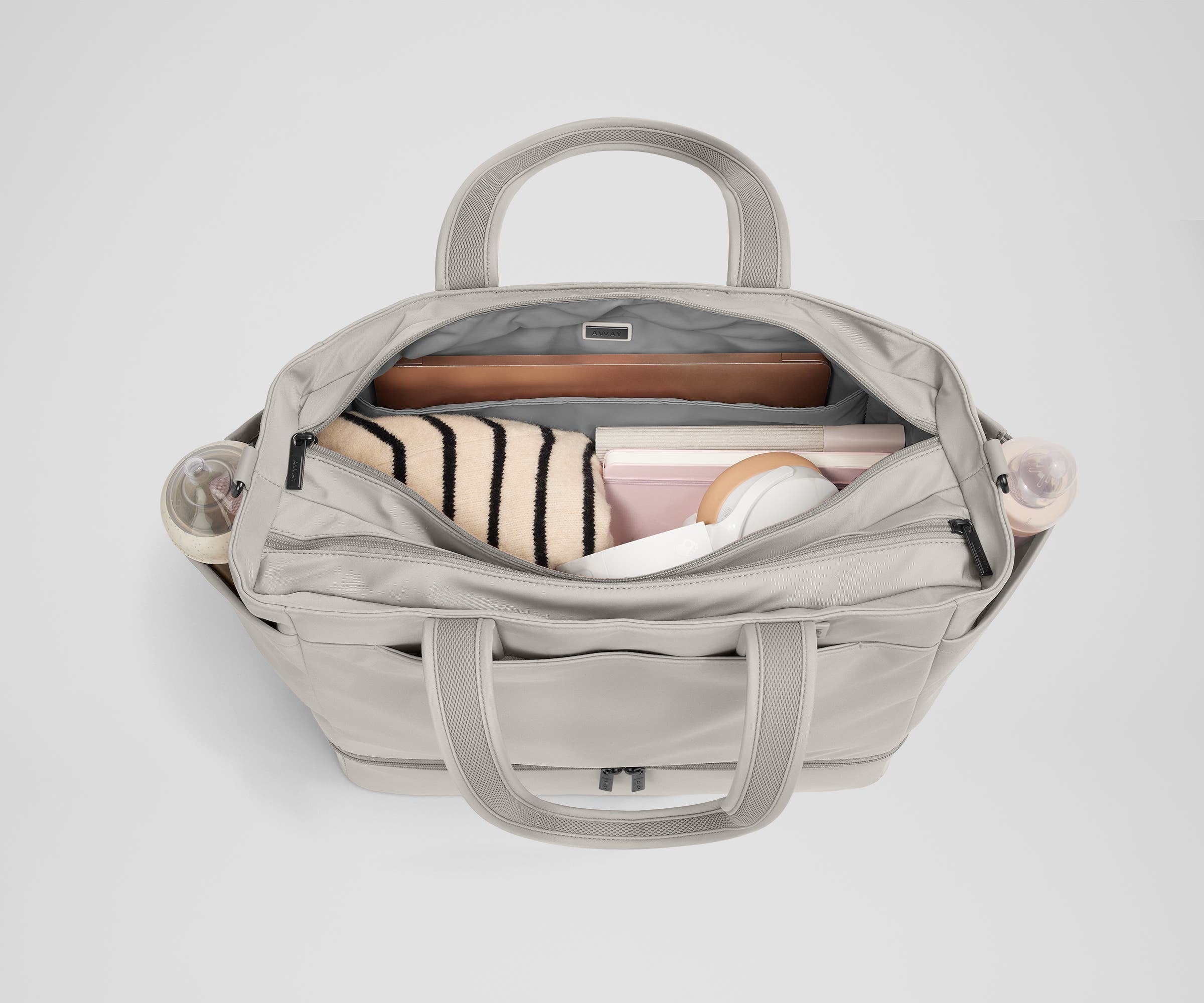 Back main compartment packed with adult travel essentials, including a laptop, notebook, and extra clothes