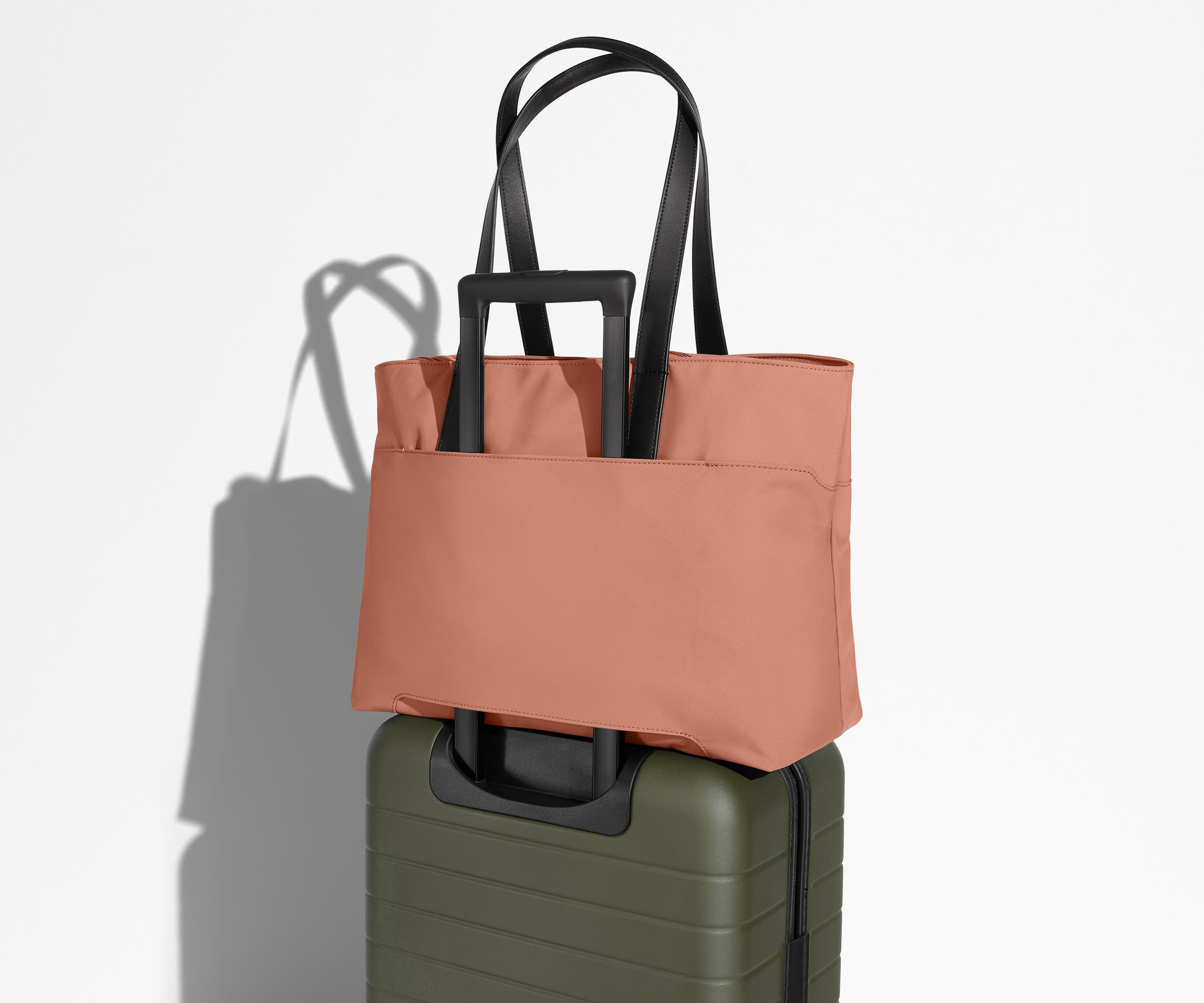 Everywhere Tote secured to an Away suitcase by its trolley sleeve