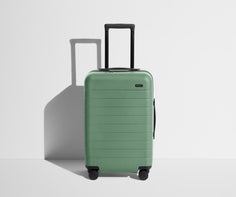 Front product view of The Carry-On suitcase in Sea Green with raised handle