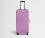 Front product view of The Trunk suitcase in Taffy Purple with raised handle