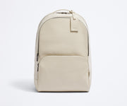 Front view of the Transit Leather Backpack and the dyed-to-match luggage tag