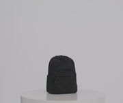 Person packing the Large Featherlight Backpack