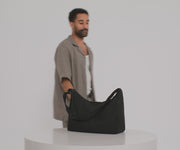 Video of a person packing the Large Featherlight Crossbody bag
